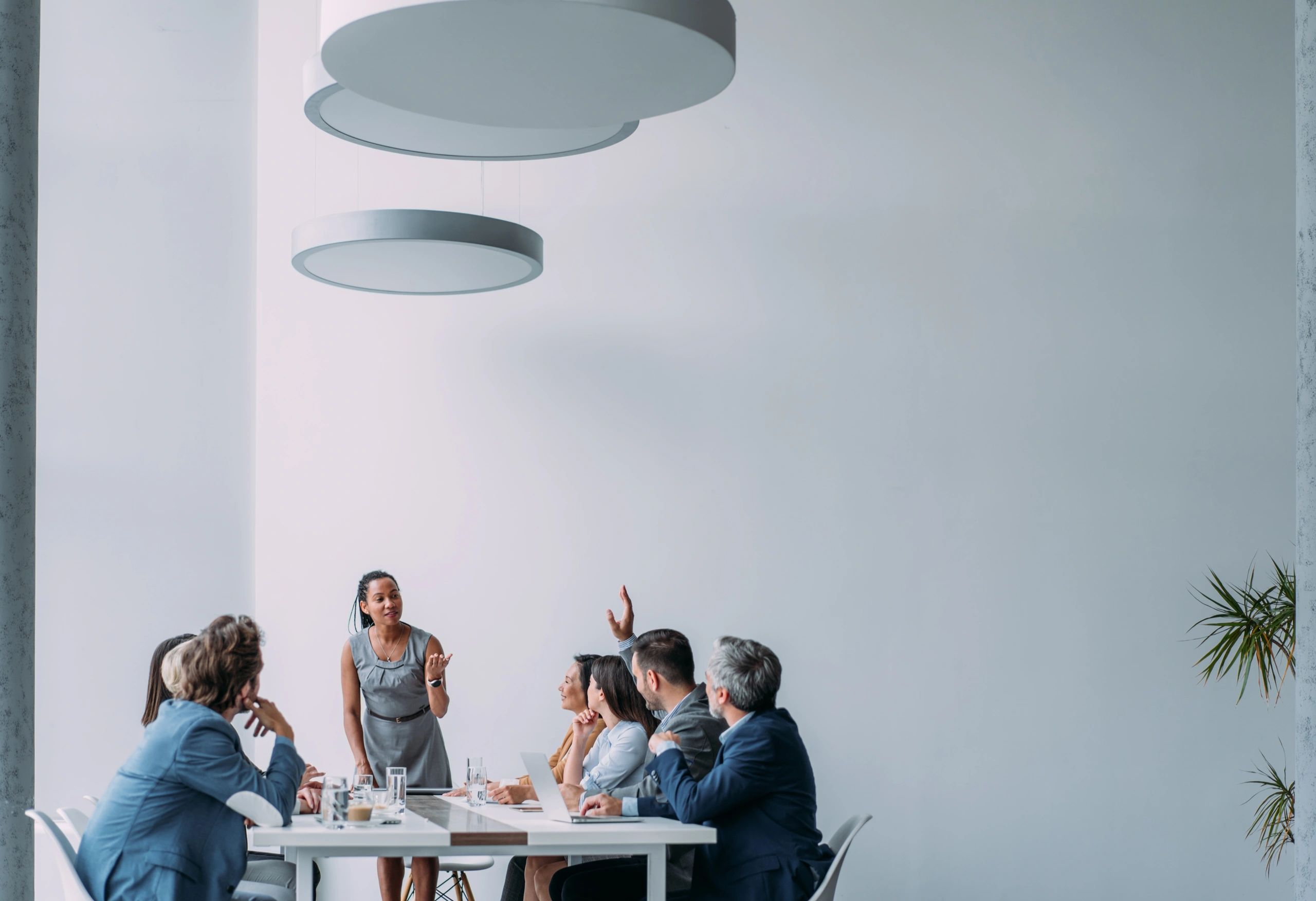 Business consultant presenting strategy to a team in a modern conference room